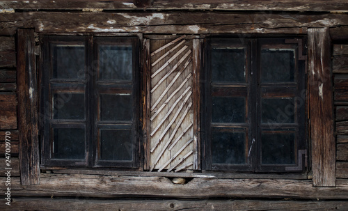 Rustic old peasant house with wooden windows