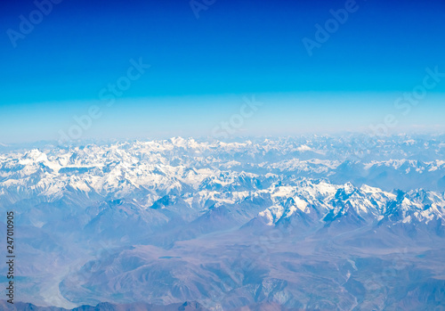 Mountains earth from aircraft under blue sky