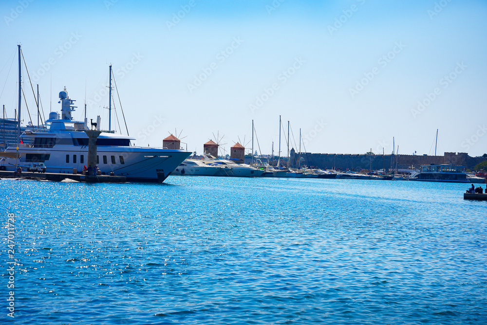The windmills,fort of St Nikolas,Church of the Assumption and the Governors palace are on Rhodes Mandraki Harbour The windmills,fort of St Nikolas,Church of the Assumption and the Governors palace are on Rhodes Mandraki Harbour