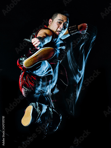 whushu chinese boxing kung fu Hung Gar fighter isolated man isolated on black background with speed light painting effect motion blur © snaptitude