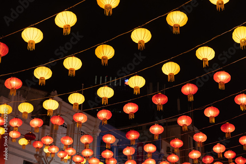 Traditional Chinese street lanterns decorations on a street of Singapore's Chinatown for Chinese New Year celebration photo