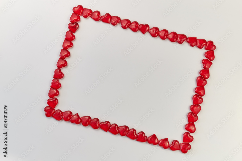 Obraz premium frame lined from small glass hearts on a white background. Valentine's Day. Love symbol