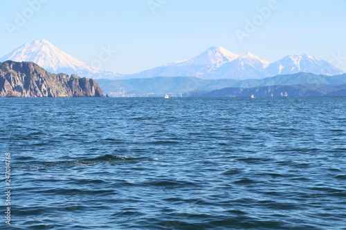 Avachinsky and Koryaksky volcanoes rises above the coastline of the Kamchatka Peninsula.