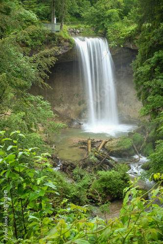 a beautiful small waterfall in a green forest in Bavaria Germany