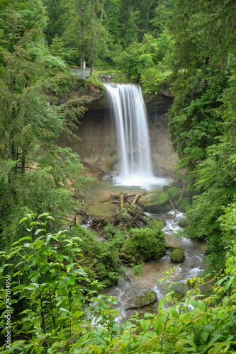 a beautiful small waterfall in a green forest in Bavaria Germany