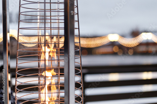 fire, warm, warms fire on the background of the city, gas lampa in a street photo