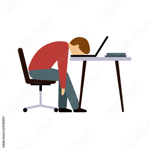 Professional burnout. A man in the office after a long hard day's work. The guy sitting at the table with his head resting on the laptop keyboard.