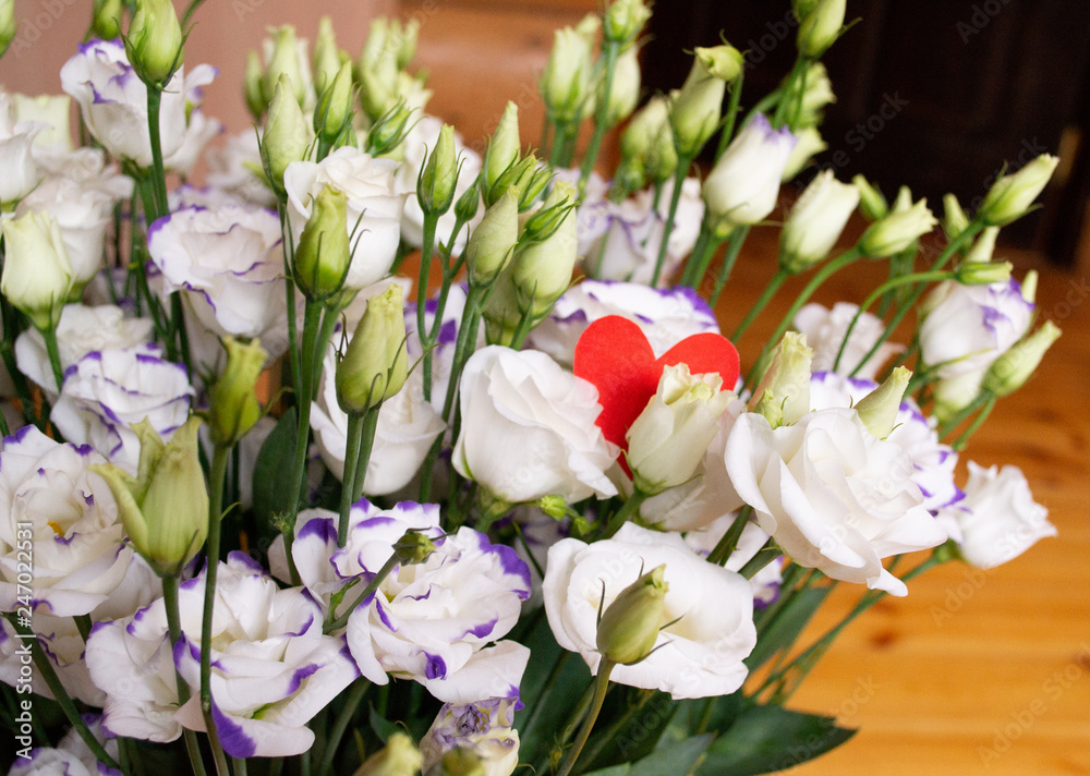 Fototapeta premium Lisianthus flowers bouquet with red heart