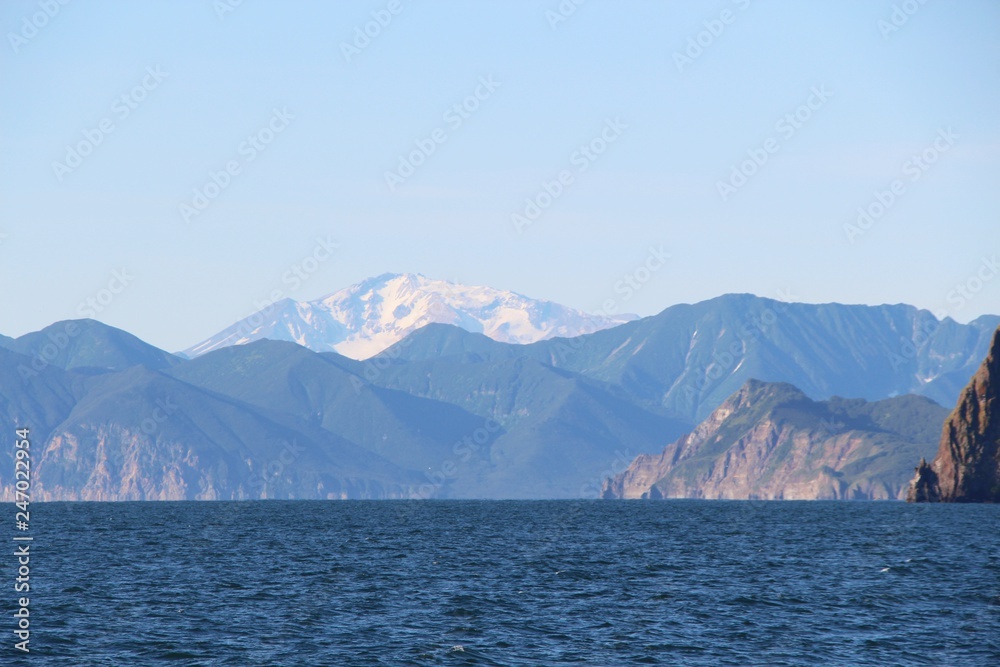 View towards Mutnovsky volcano from water on Kamchatka Peninsula, Russia. It is one of the most active volcanoes of southern Kamchatka; the latest eruption was recorded in 2000.