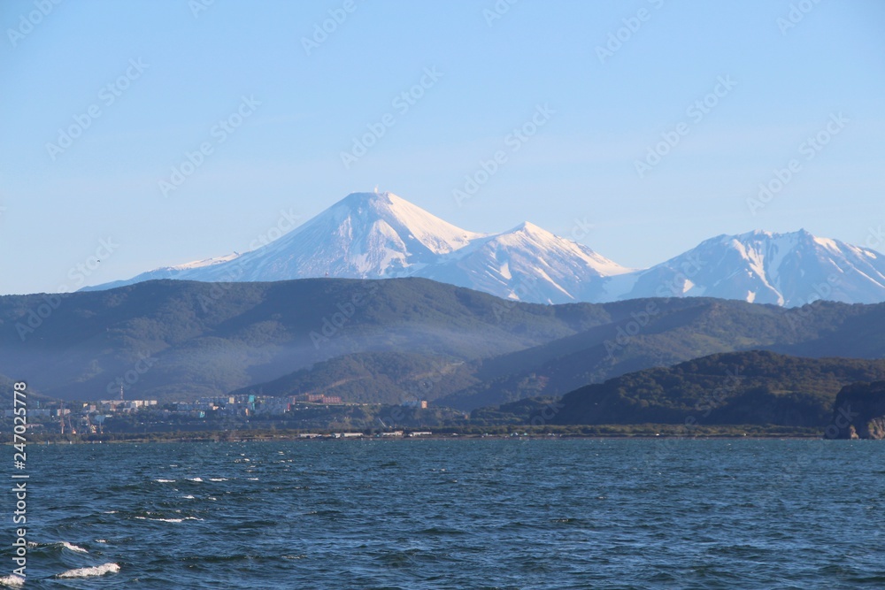 Avachinsky and Kozelsky volcanoes towers over the city of Petropavlovsk-Kamchatsky on the Kamchatka Peninsula, Russia