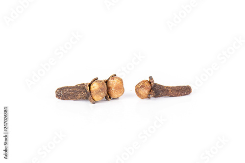 Group of two whole small dried cloves spice isolated on white background