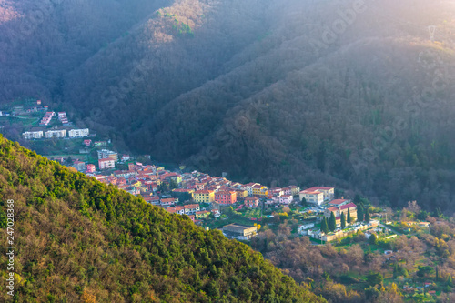 Small town in a mountain valley among the forest.