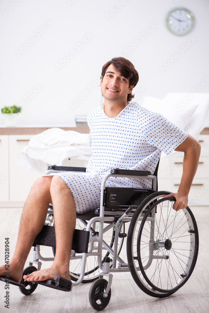 Young handsome man in wheelchair at the hospital Young handsome man in wheelchair at the hospital
