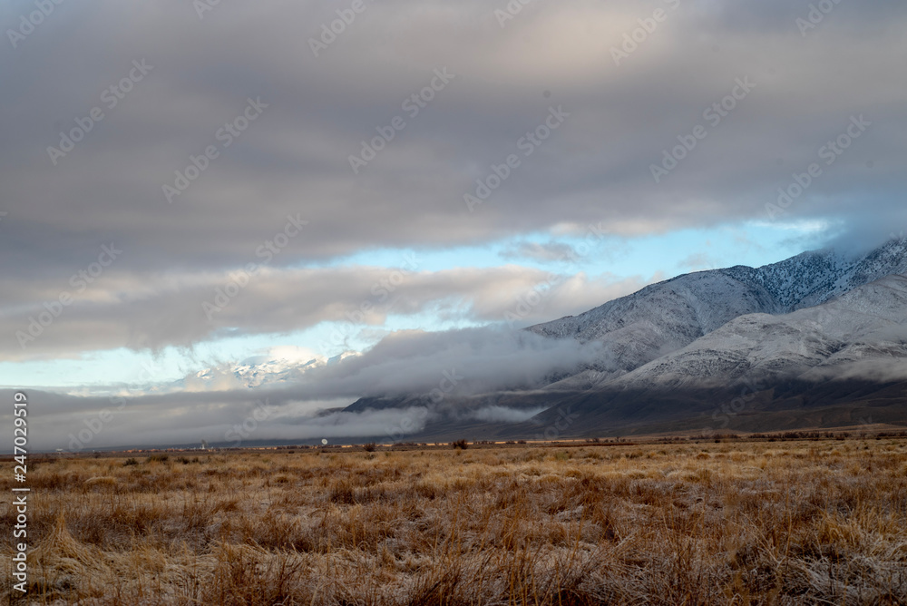 winter valley clouds hang around mountain range snowy peaks morning winter valley clouds hang around mountain range snowy peaks morning