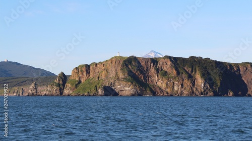 View of coastline of the Kamchatka Peninsula, Russia. In the background is visible Vilyuchinsky volcano (also called Vilyuchik).