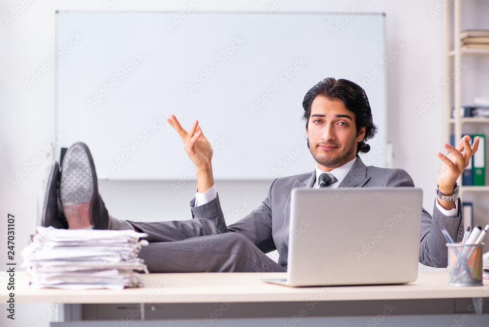 Young handsome businessman employee in the office Young handsome businessman employee in the office