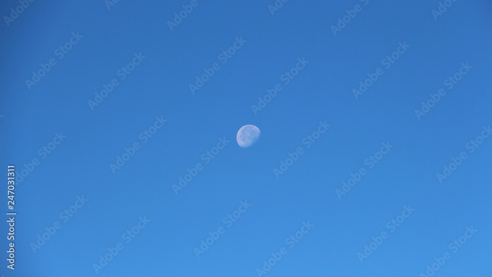 View of the old moon in the daytime sky View of the old moon in the daytime sky