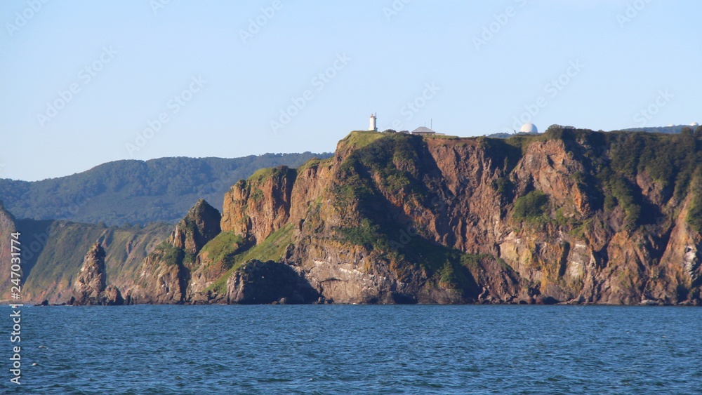 View of the coastal cliffs of the Kamchatka Peninsula, Russia. The Kamchatka peninsula contains the volcanoes of Kamchatka, a UNESCO World Heritage Site. View of the coastal cliffs of the Kamchatka Peninsula, Russia. The Kamchatka peninsula contains the volcanoes of Kamchatka, a UNESCO World Heritage Site.