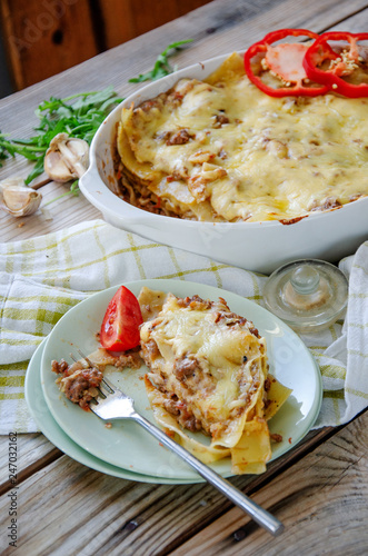 Traditional lasagna made with minced beef bolognese sauce and bechamel sauce with pepper and herbs