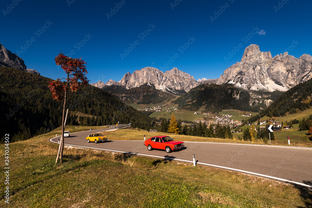 oldtimer in autumn on a pass road with blue sky