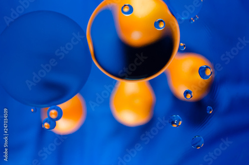 Orange funny smiley face on a blue canvas