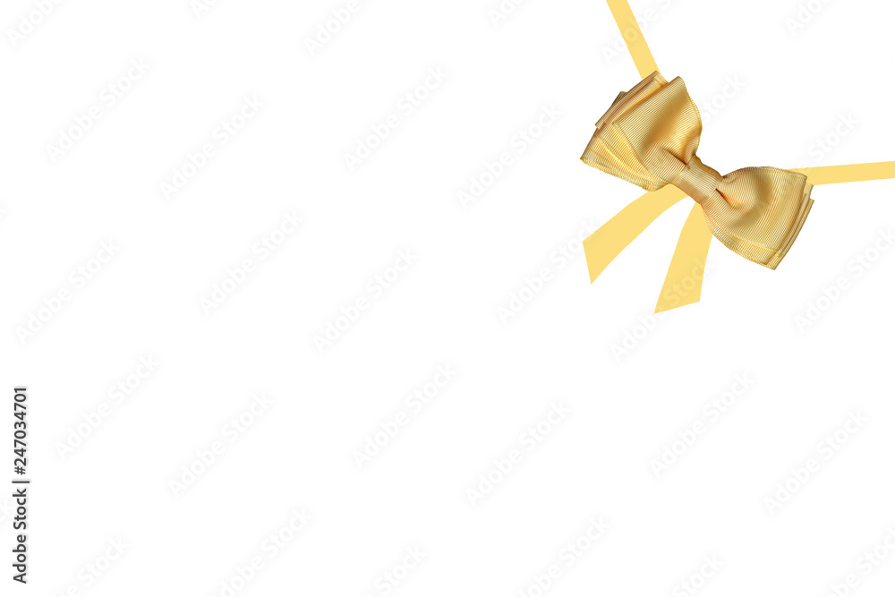 Gift bows. A decorative gold shiny bow made of satin with painted ribbons for gift box isolated on a white background. Decorations background.
