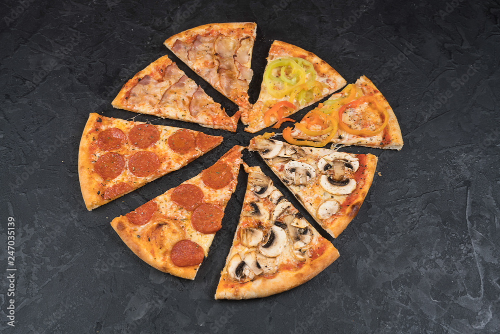 Italian pizza with two different flavors on a lack background isolated top view of tasty and appetizing