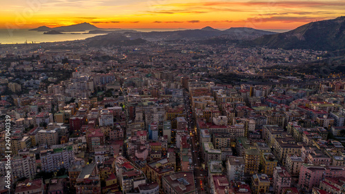 Aerial view at sunset of the hill and residential district of Vomero in Naples, Italy. Many are the buildings built in the narrow streets of the city. In the Backgroung Nisida Island and Fuorigrotta. photo