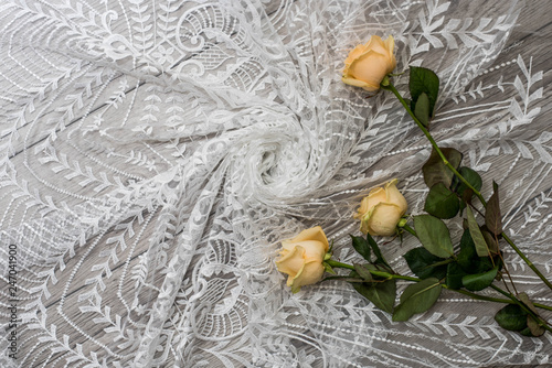 The texture of lace on wooden background decoreted roses. photo