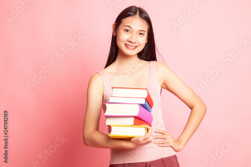 Young Asian woman studying with may books.