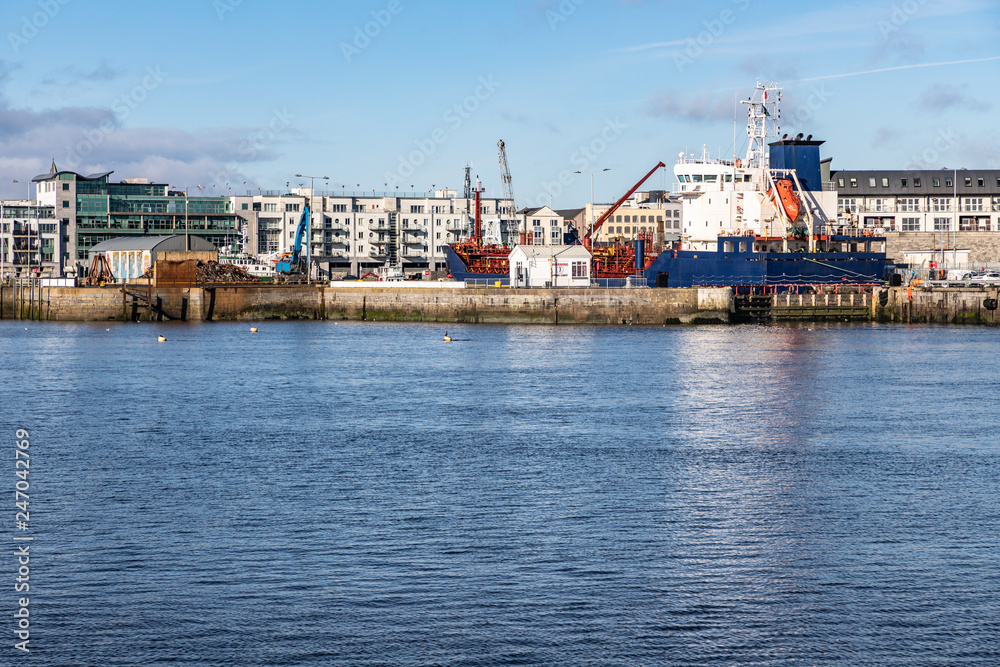 Galway harbour, Corrib river and Galway buildings with reflection