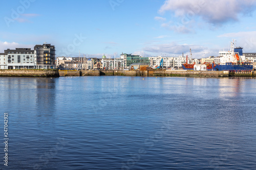 Galway harbour, Corrib river and Galway buildings with reflection