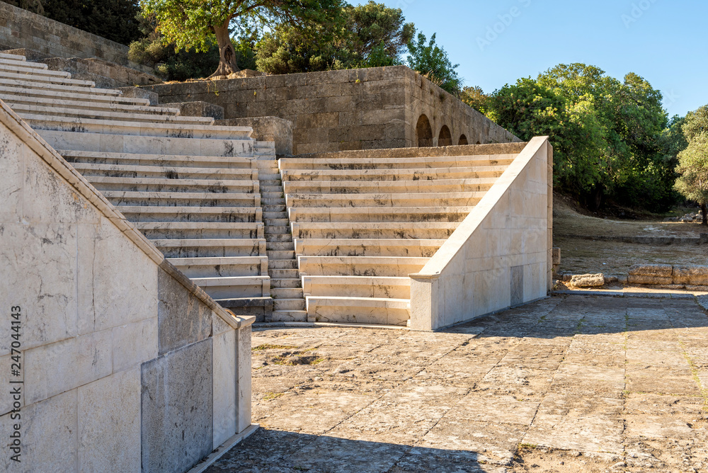 Ancient theater with marble seats and stairs. The Acropolis of Rhodes. Rhodes island, Greece