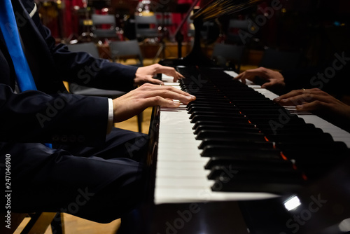 Professional pianist performing a piece on a grand piano.