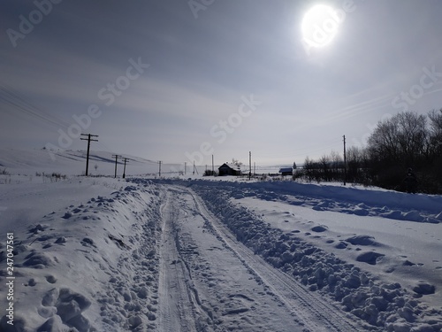 winter landscape with road and blue sky