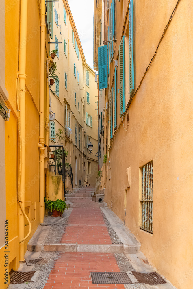 Menton, narrow street in the old town, French Riviera, typical houses