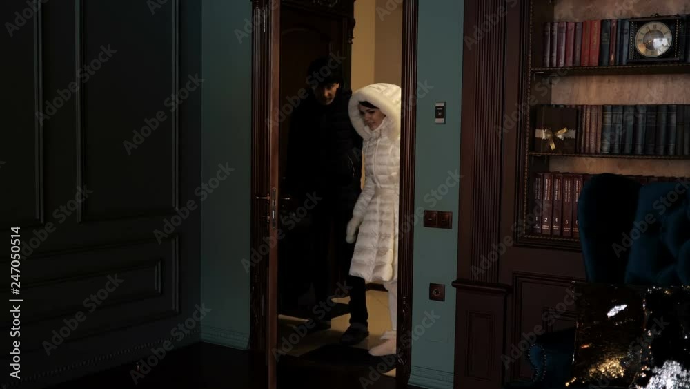 man and a woman with a suitcase come into the house man and a woman with a suitcase come into the house