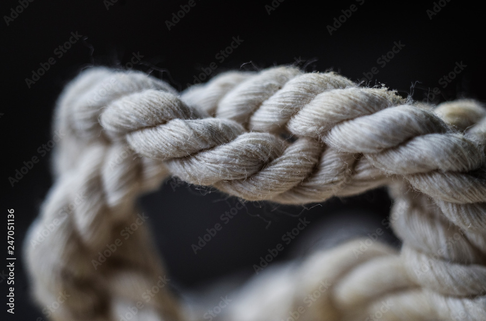 Cotton twisted rope in natural color on black background