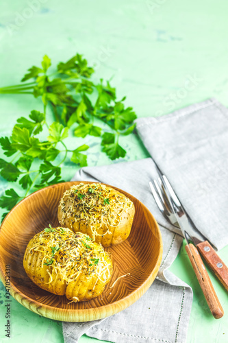 Portion baked potatoes with green onion and cheese