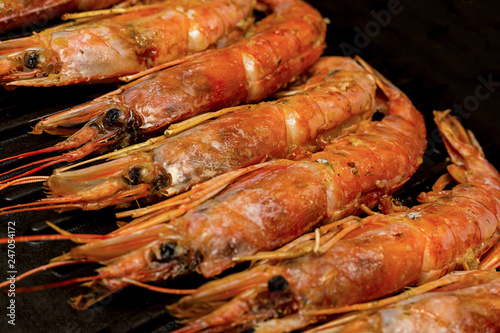 appetizer for beer large red shrimps argentine in chitin one-piece set lies on grill raw stage cooking sea food menu background