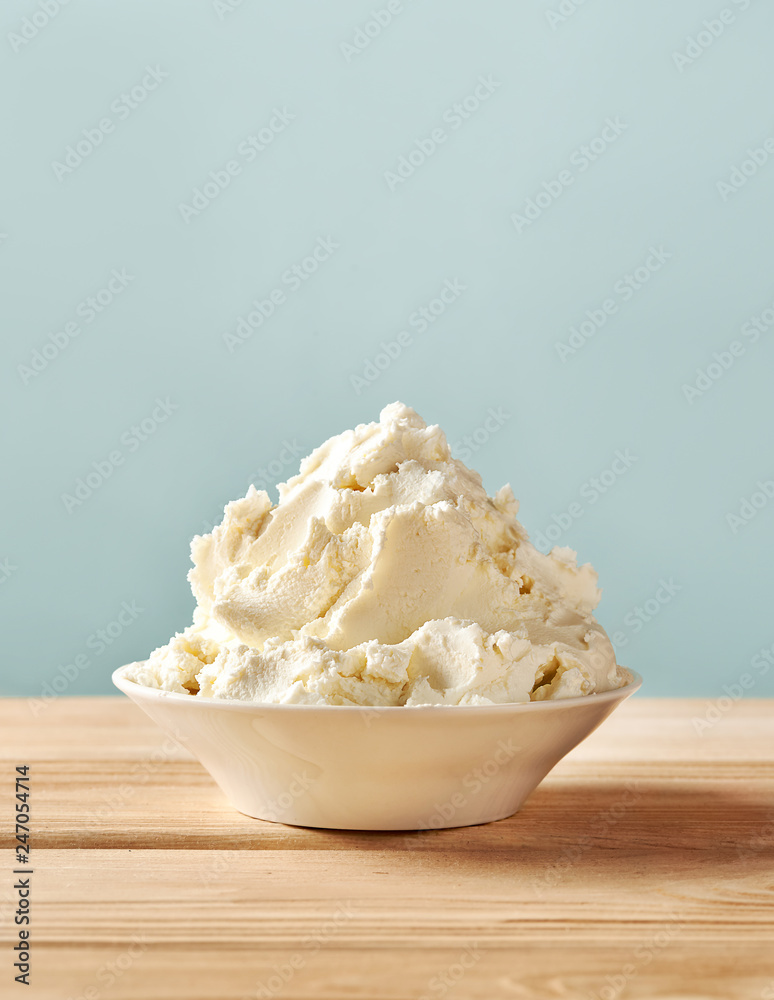Mascarpone cheese on wooden table. Homemade soft cream cheese. Mascarpone cheese on wooden table. Homemade soft cream cheese.