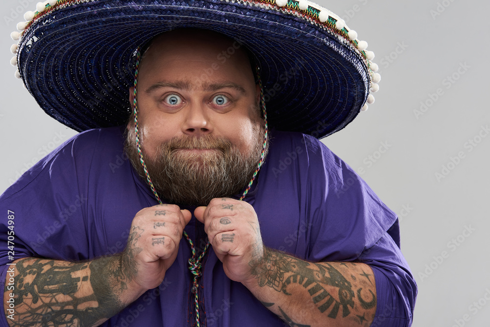 Close up of funny fat man in sombrero clenching his fists Stock Photo |  Adobe Stock