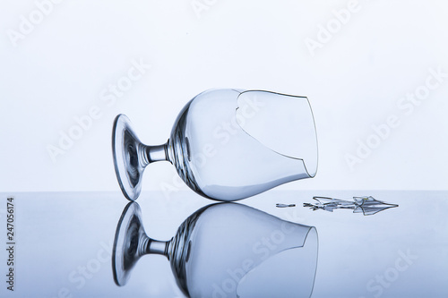 broken glass with fragments on the table on a white background