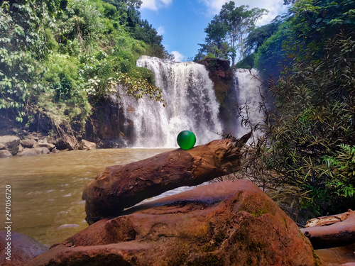 Kachang waterfall in forest and green ball on the tree photo