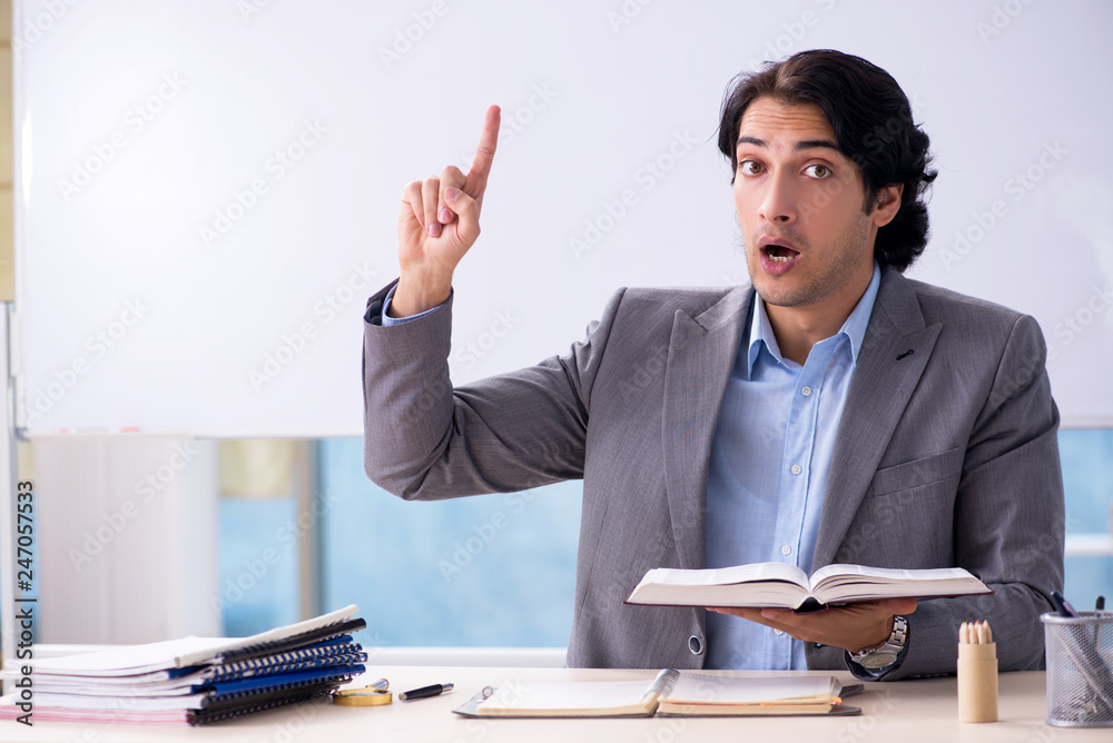 Young handsome teacher in front of whiteboard Young handsome teacher in front of whiteboard