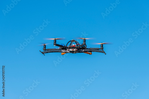 Professional drone flying with landing gear retracted