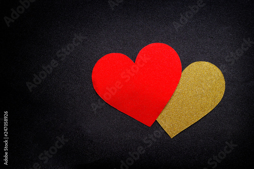 Love hearts on black background. Valentine's day card concept. Gold and red heart on black background