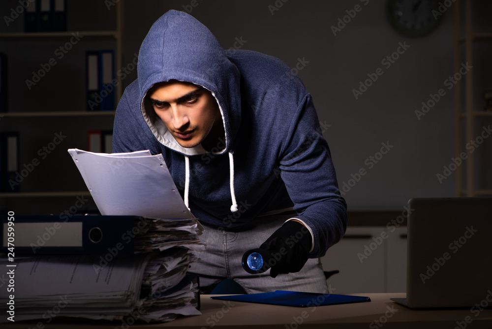 Thief trying to steal personal data in identity theft concept Thief trying to steal personal data in identity theft concept