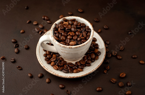 Coffee cup and beans on a concrete table