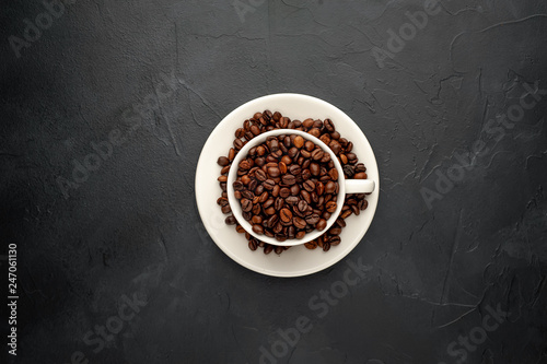 Coffee cup and beans on a concrete table